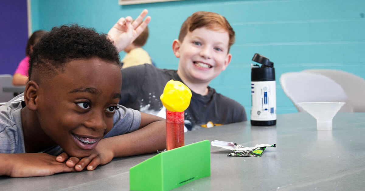 catawba science center homeschool classes kids enjoying learning at desk smiling