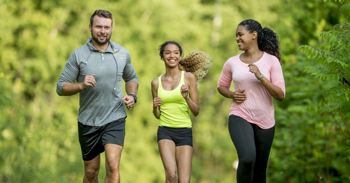 people running in forest field day community connection