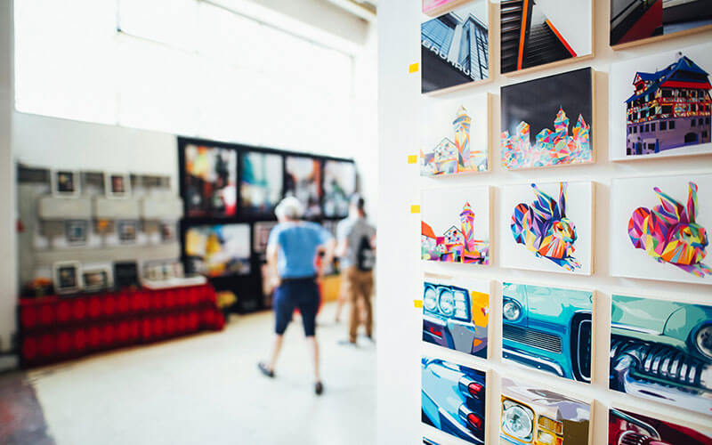 Visitors viewing artwork at a community arts and culture nonprofit exhibition supporting creativity and recreation.